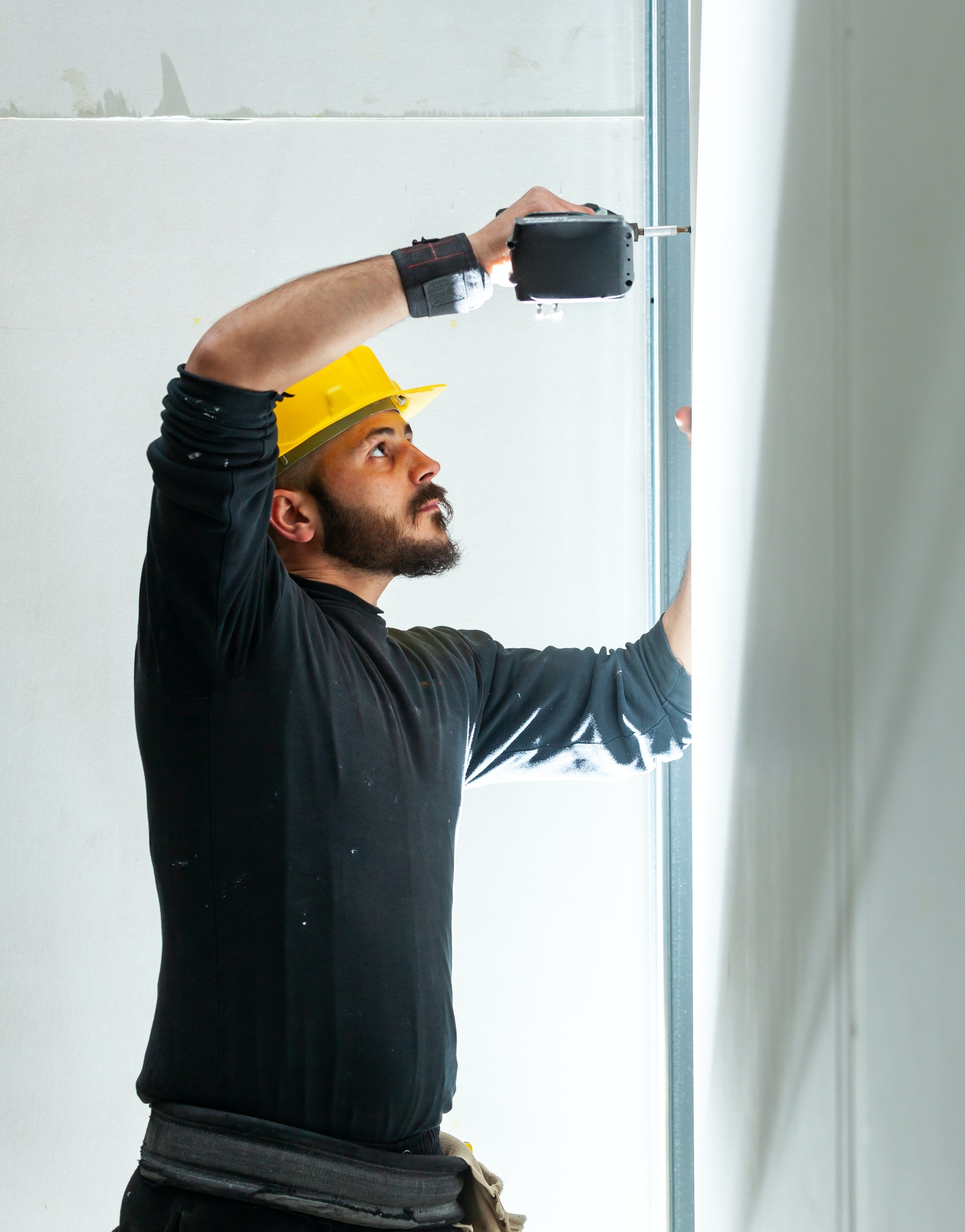 Worker builds a plasterboard wall.